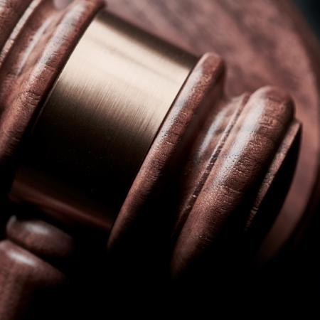 A gavel with a black background